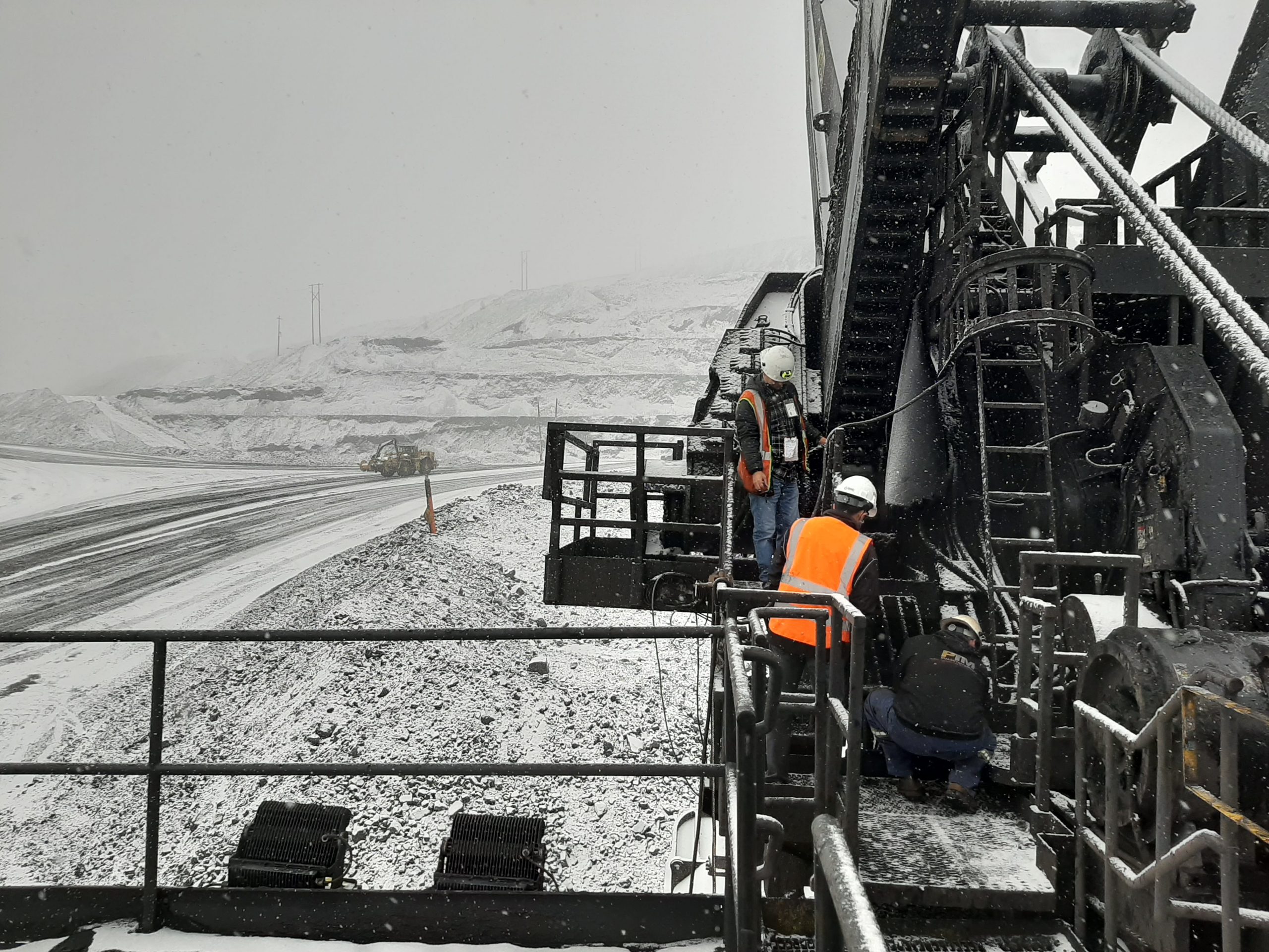 RIGID staff working on a shovel at a snow-covered mine site